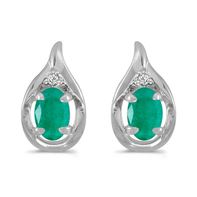 These 14k white gold oval emerald and diamond earrings feature 6x4 mm genuine natural emeralds wi...