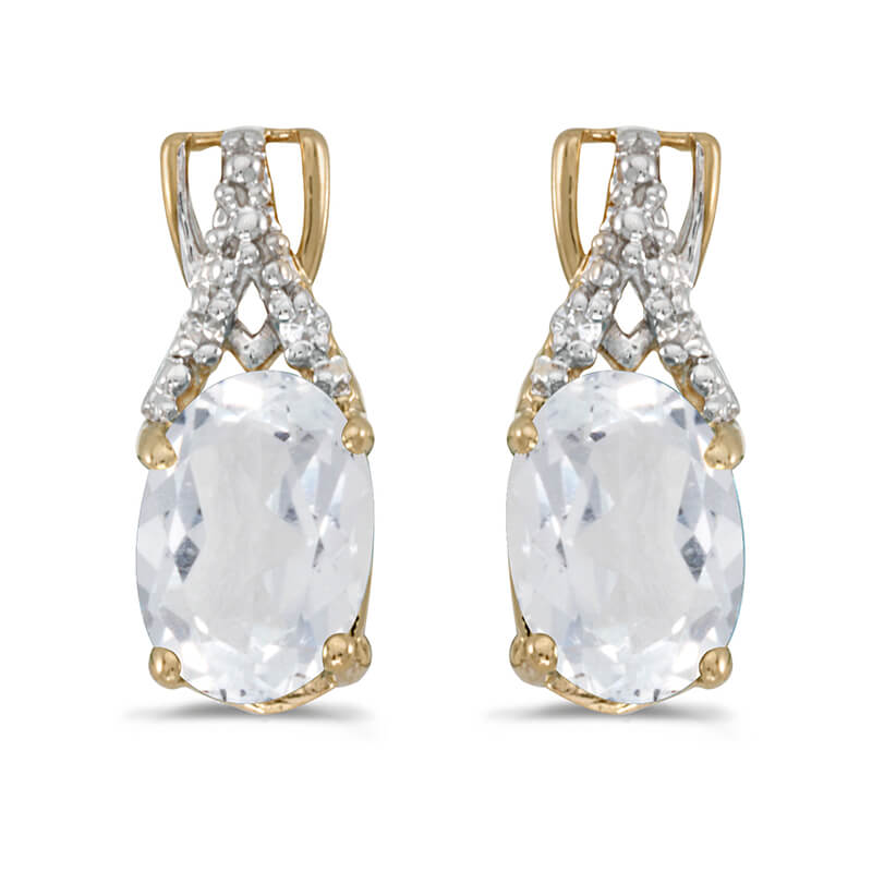 These 14k yellow gold oval white topaz and diamond earrings feature 7x5 mm genuine natural white ...