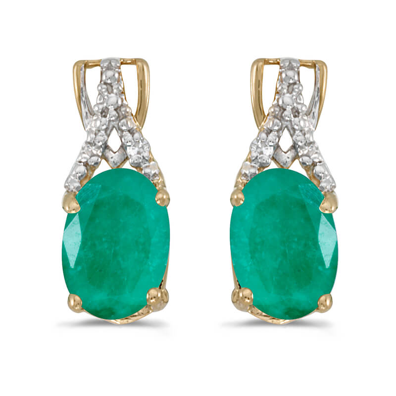 These 14k yellow gold oval emerald and diamond earrings feature 7x5 mm genuine natural emeralds w...