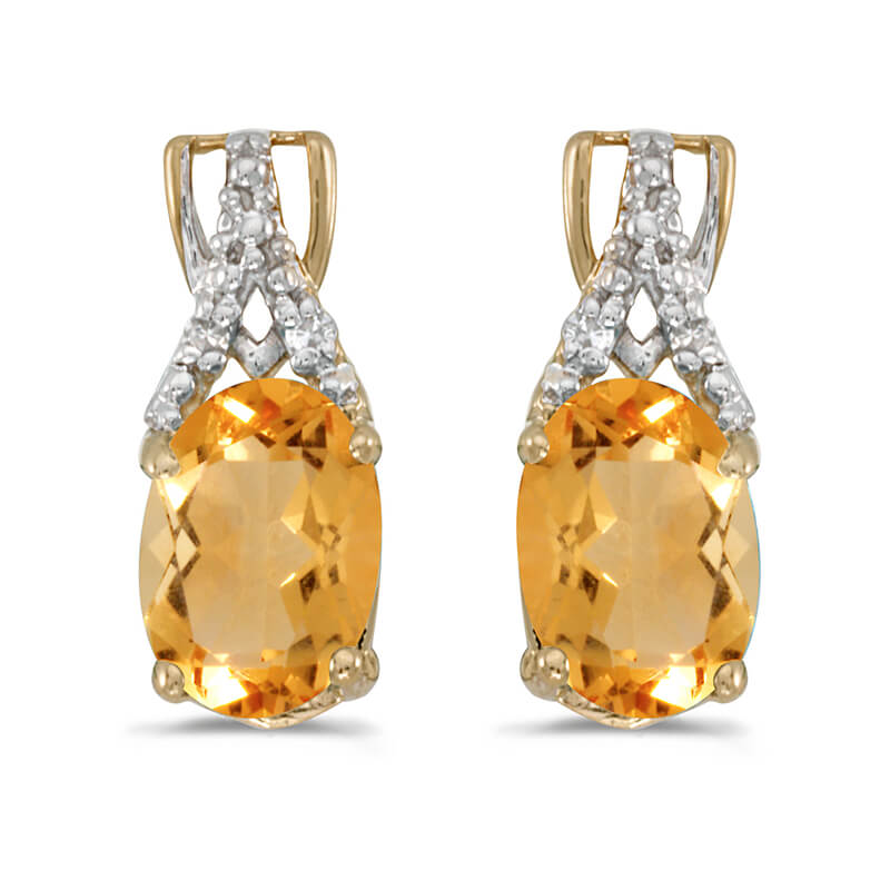 These 14k yellow gold oval citrine and diamond earrings feature 7x5 mm genuine natural citrines w...