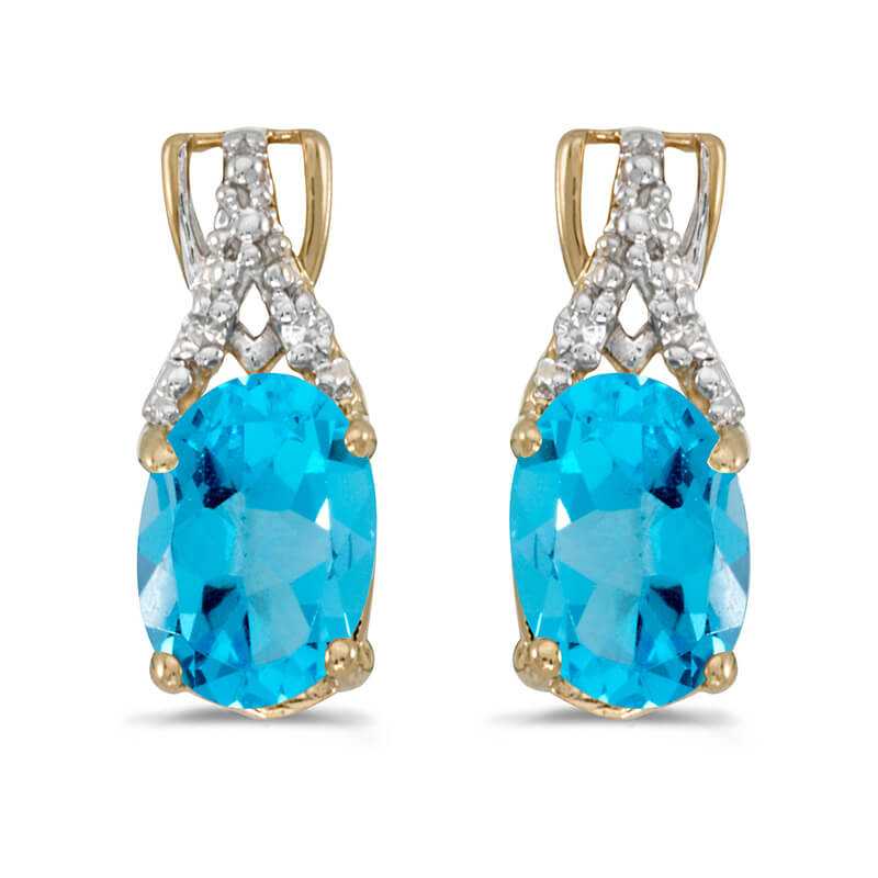 These 14k yellow gold oval blue topaz and diamond earrings feature 7x5 mm genuine natural blue to...