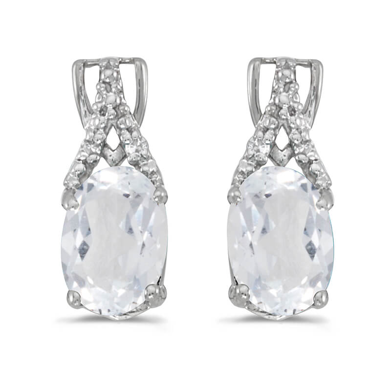 These 14k white gold oval white topaz and diamond earrings feature 7x5 mm genuine natural white topazs with a 1.84 ct total weight and sparkling diamond accents.