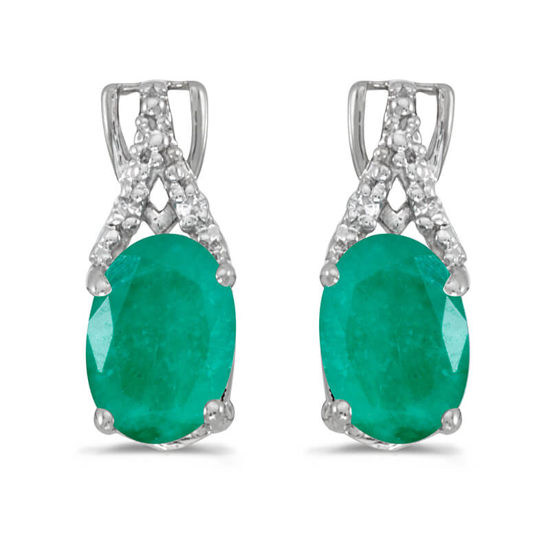 These 14k white gold oval emerald and diamond earrings feature 7x5 mm genuine natural emeralds wi...
