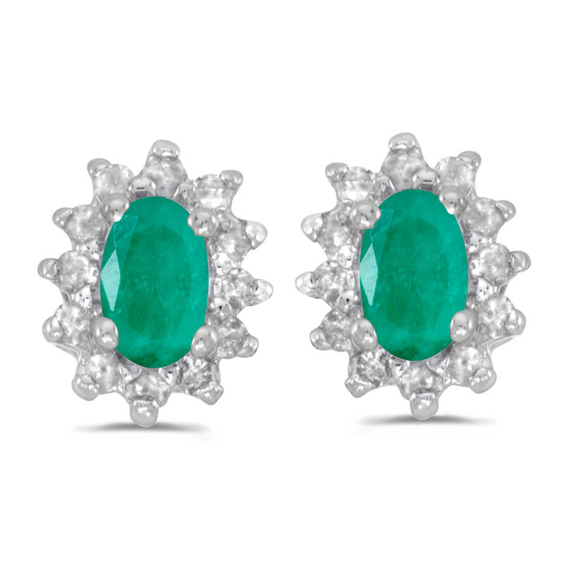 These 14k white gold oval emerald and .25 ct diamond earrings feature 5x3 mm genuine natural emer...