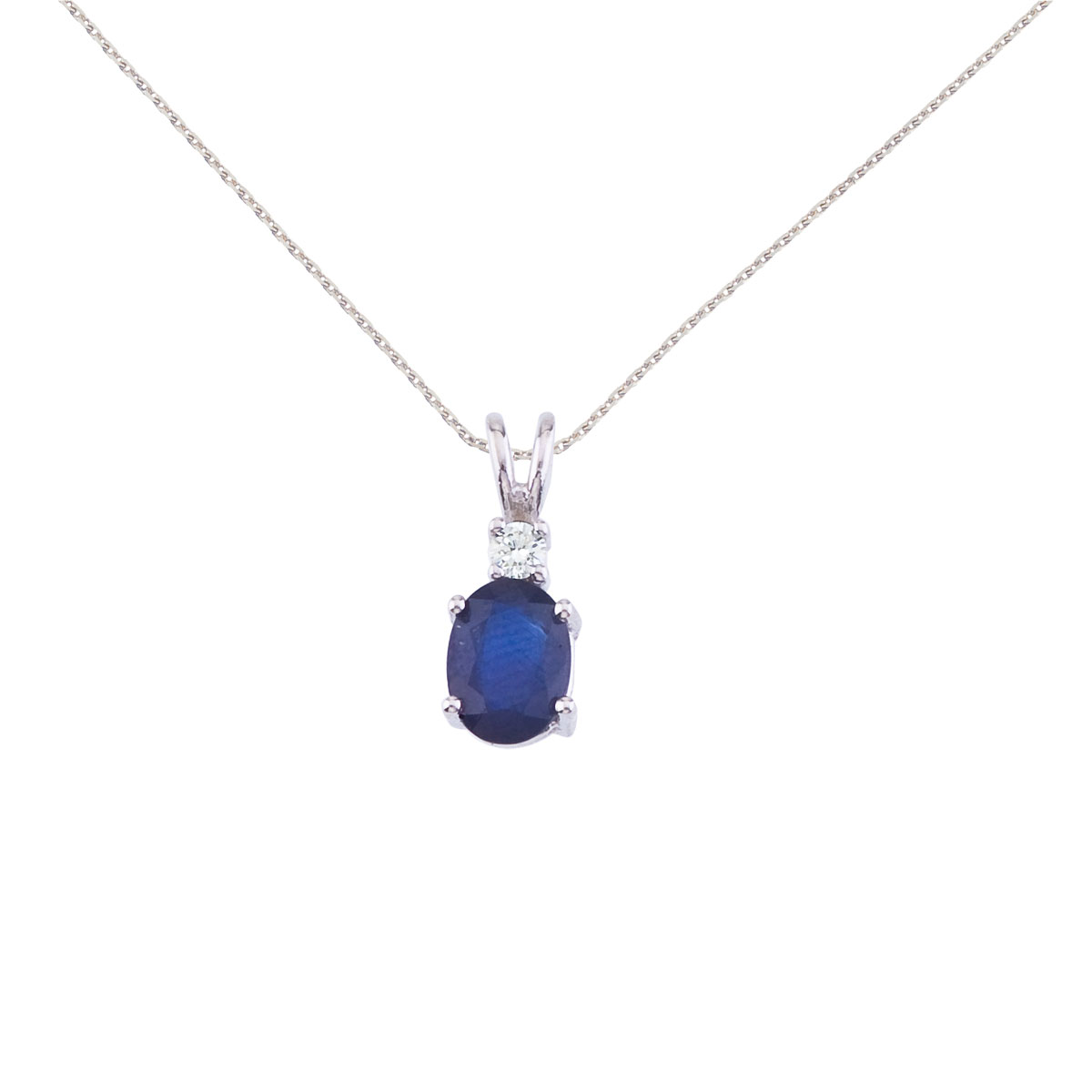 7x5 mm natural sapphire and diamond pendant set in 14k white gold.