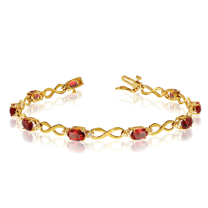 This 10k yellow gold oval garnet and diamond bracelet features nine 6x4 mm stunning natural garne...