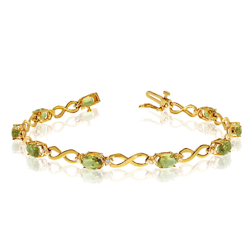 This 10k yellow gold oval peridot and diamond bracelet features nine 6x4 mm stunning natural peri...
