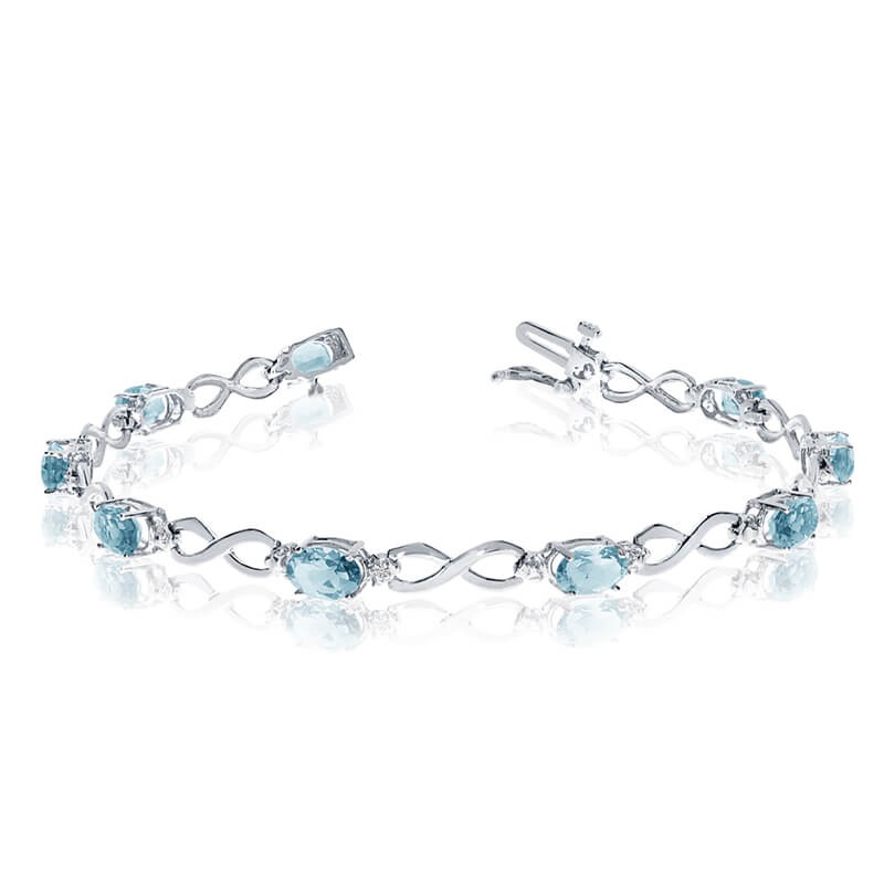 This 10k white gold oval aquamarine and diamond bracelet features nine 6x4 mm stunning natural aq...