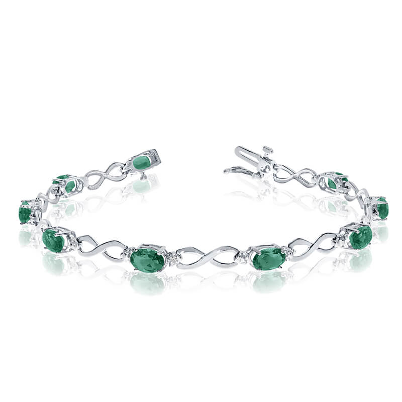 This 10k white gold oval emerald and diamond bracelet features nine 6x4 mm stunning natural emera...