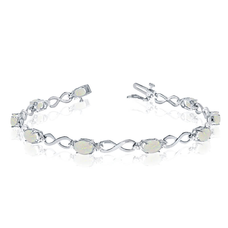 This 10k white gold oval opal and diamond bracelet features nine 6x4 mm stunning natural opal sto...