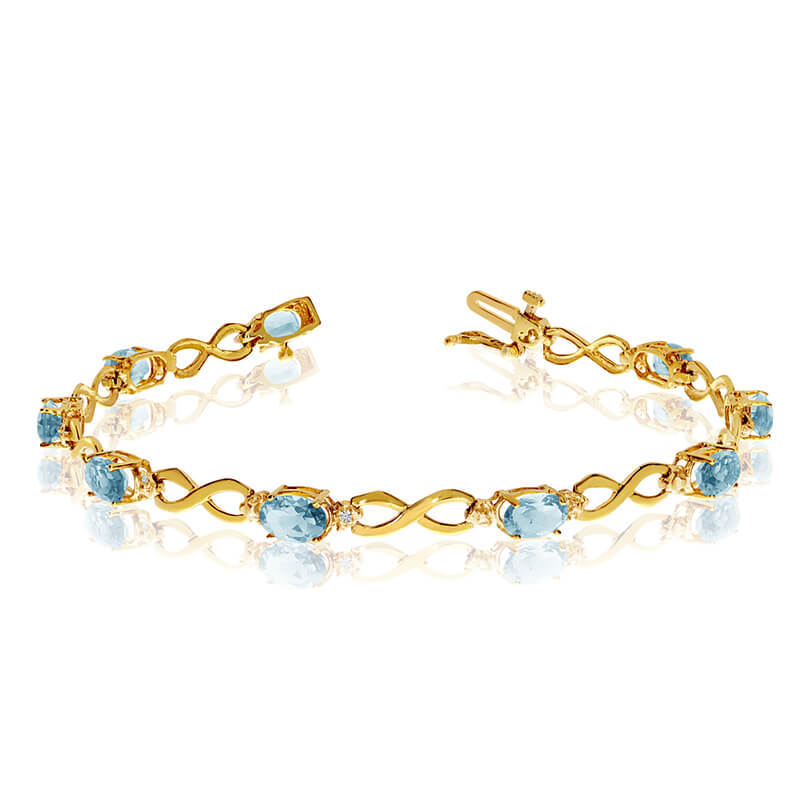 This 14k yellow gold oval aquamarine and diamond bracelet features nine 6x4 mm stunning natural a...