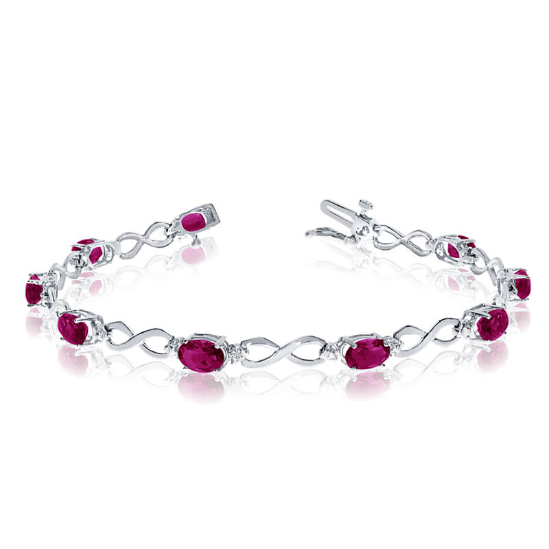 This 14k white gold oval ruby and diamond bracelet features nine 6x4 mm stunning natural ruby sto...