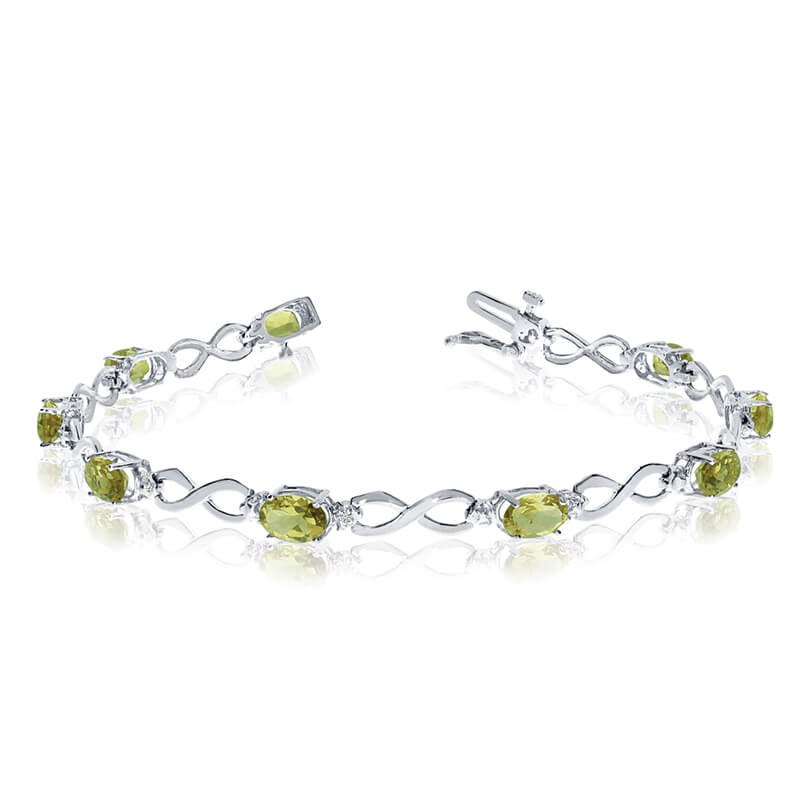 This 14k white gold oval peridot and diamond bracelet features nine 6x4 mm stunning natural perid...
