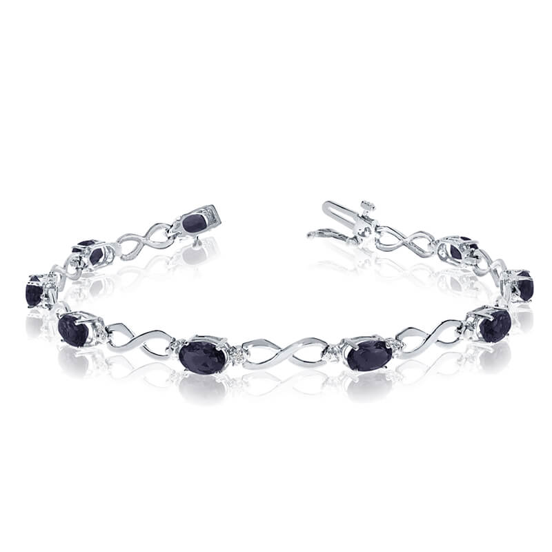 This 14k white gold oval sapphire and diamond bracelet features nine 6x4 mm stunning natural sapp...