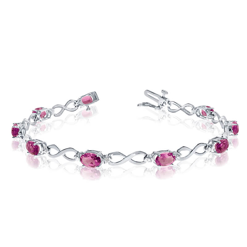 This 14k white gold oval pink topaz and diamond bracelet features nine 6x4 mm stunning natural pi...