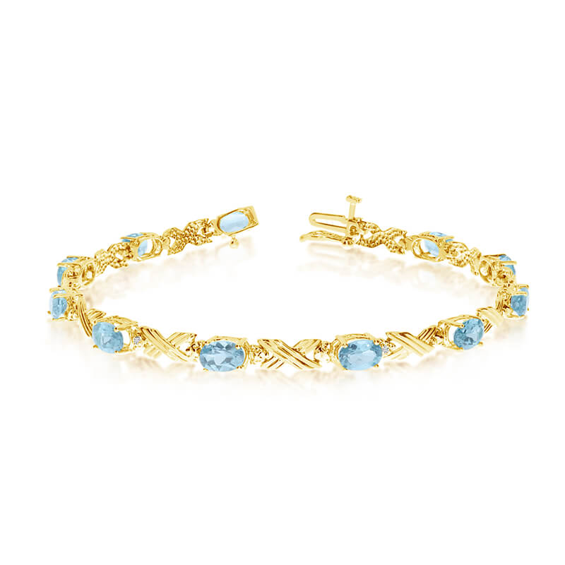 This 10k yellow gold oval aquamarine and diamond bracelet features eleven 6x4 mm stunning natural...