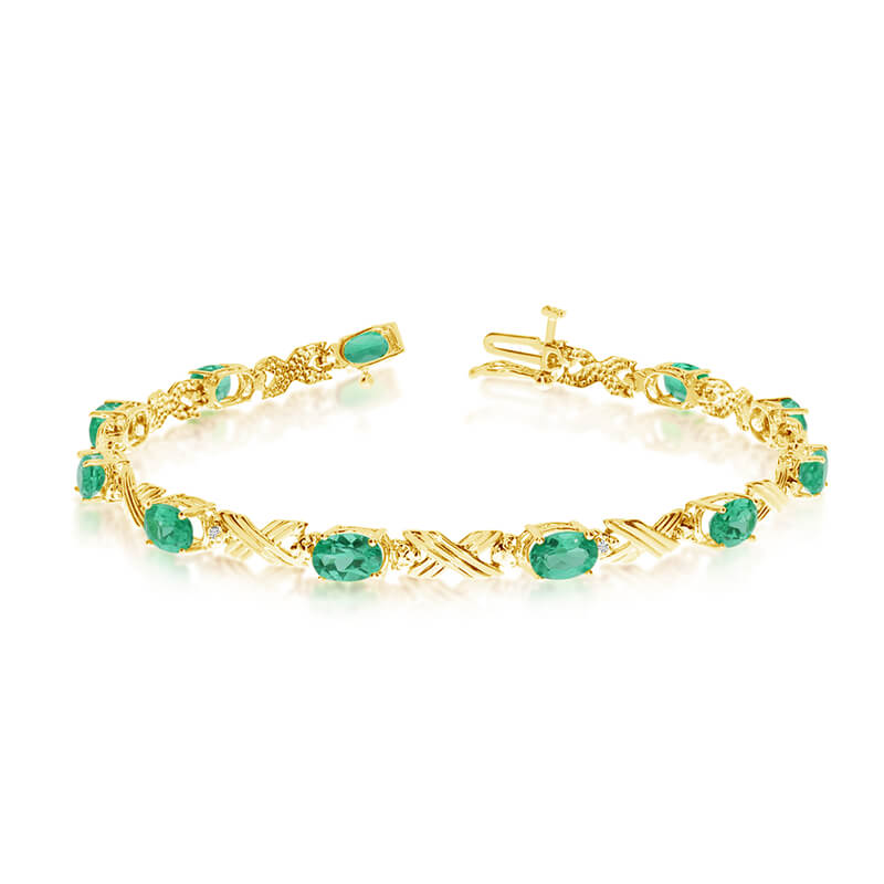 This 10k yellow gold oval emerald and diamond bracelet features eleven 6x4 mm stunning natural em...