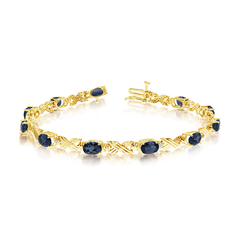 This 10k yellow gold oval sapphire and diamond bracelet features eleven 6x4 mm stunning natural s...
