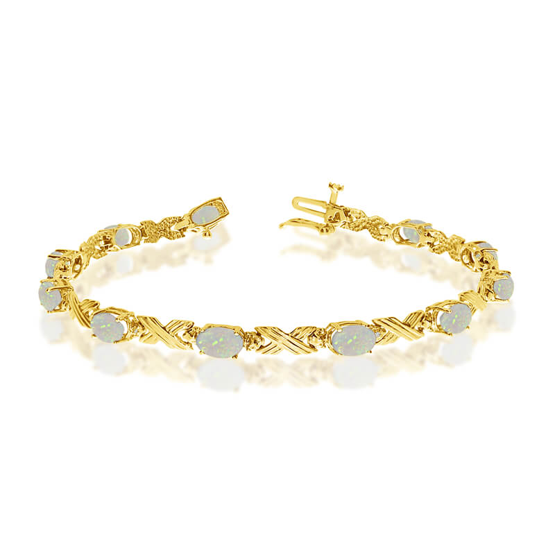 This 10k yellow gold oval opal and diamond bracelet features eleven 6x4 mm stunning natural opal ...