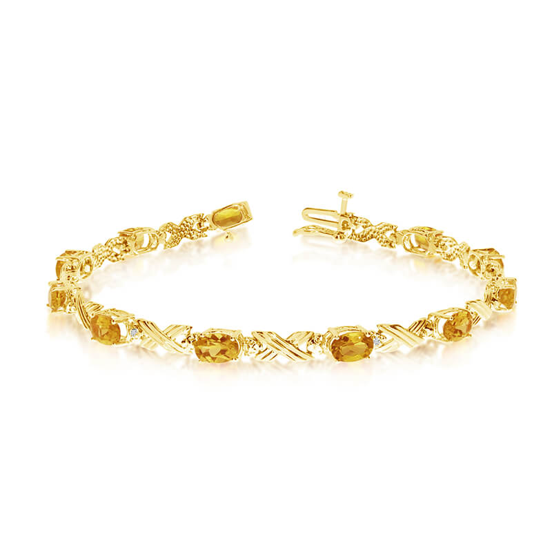 This 10k yellow gold oval citrine and diamond bracelet features eleven 6x4 mm stunning natural ci...
