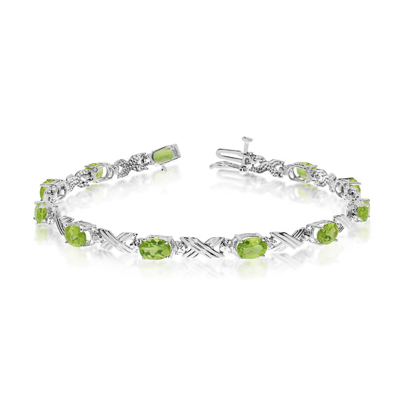 This 10k white gold oval peridot and diamond bracelet features eleven 6x4 mm stunning natural per...