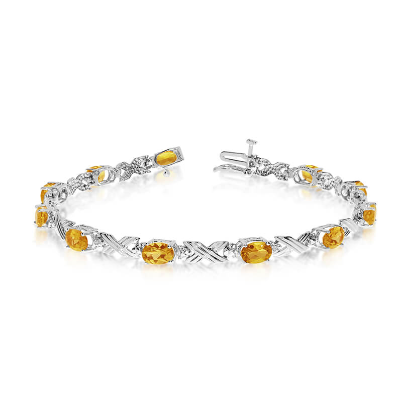 This 10k white gold oval citrine and diamond bracelet features eleven 6x4 mm stunning natural cit...