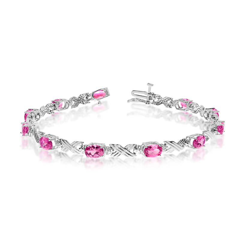 This 10k white gold oval pink topaz and diamond bracelet features eleven 6x4 mm stunning natural ...