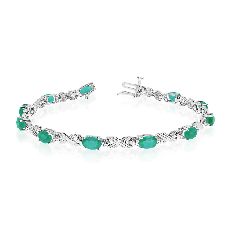 This 14k white gold oval emerald and diamond bracelet features eleven 6x4 mm stunning natural eme...