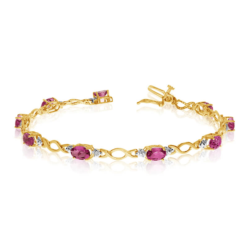 This 10k yellow gold oval ruby and diamond bracelet features ten 6x4 mm stunning natural ruby sto...