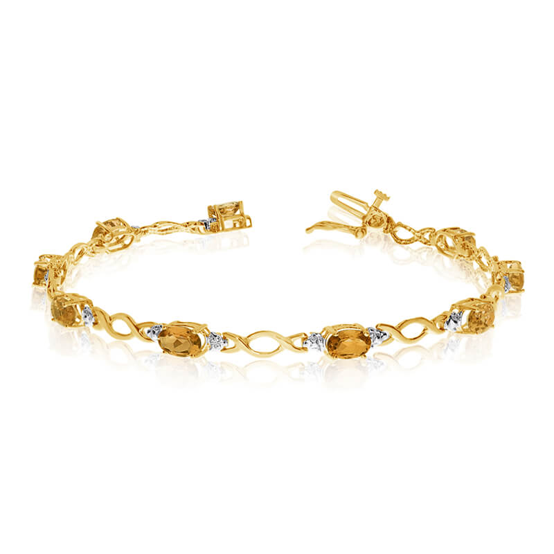 This 10k yellow gold oval citrine and diamond bracelet features ten 6x4 mm stunning natural citri...