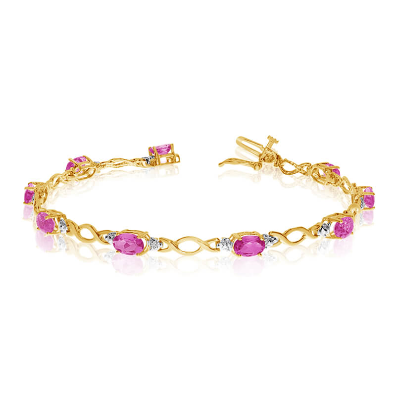 This 10k yellow gold oval pink topaz and diamond bracelet features ten 6x4 mm stunning natural pi...