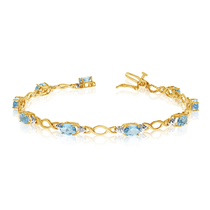This 14k yellow gold oval aquamarine and diamond bracelet features ten 6x4 mm stunning natural aq...