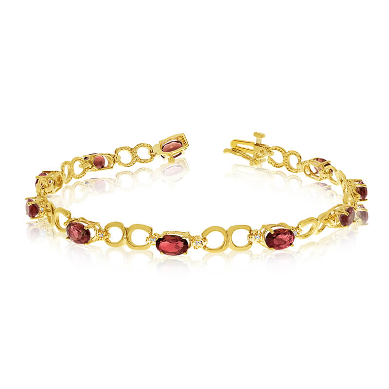 This 10k yellow gold oval garnet and diamond bracelet features ten 6x4 mm stunning natural garnet...