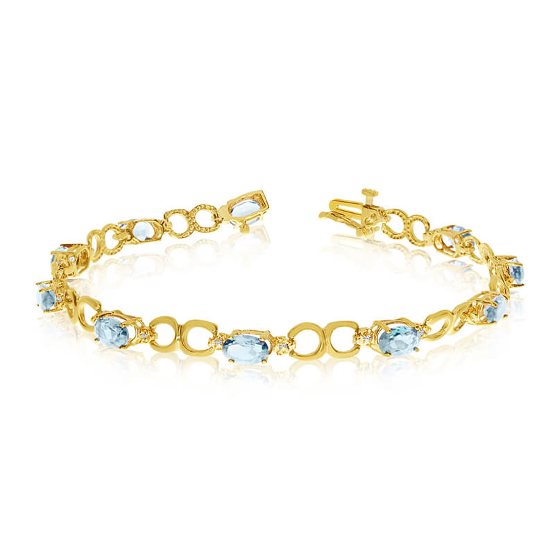 This 10k yellow gold oval aquamarine and diamond bracelet features ten 6x4 mm stunning natural aq...