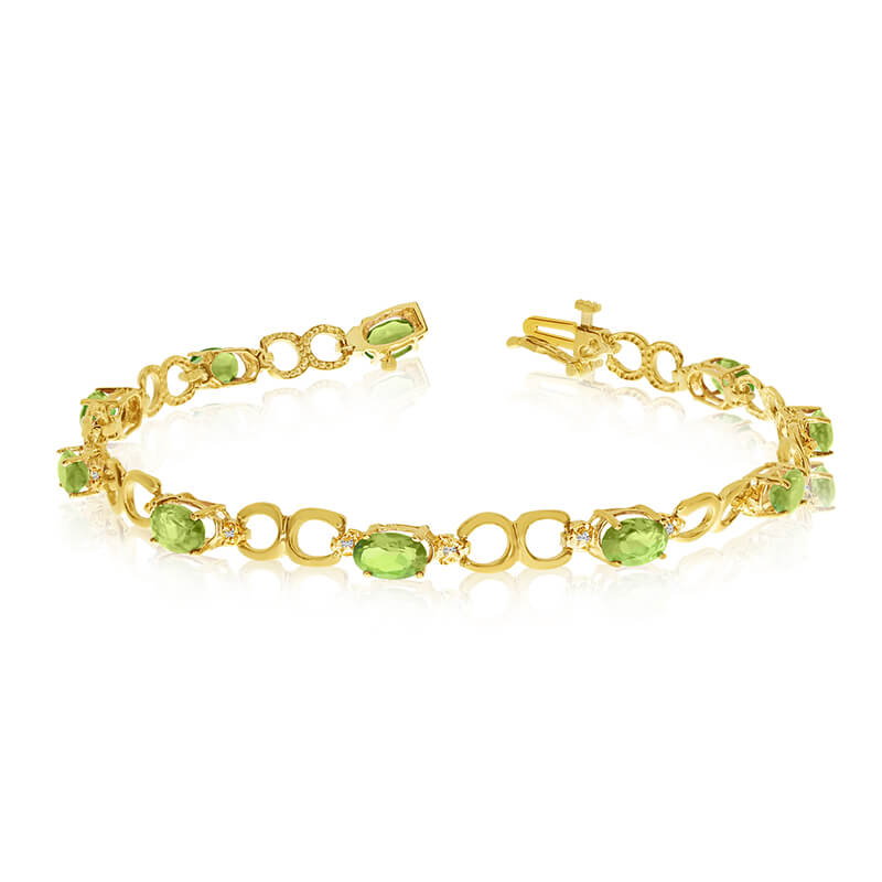 This 10k yellow gold oval peridot and diamond bracelet features ten 6x4 mm stunning natural perid...