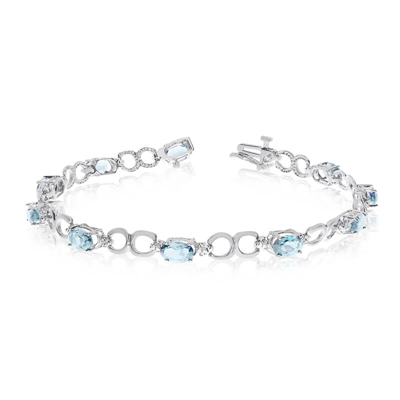 This 10k white gold oval aquamarine and diamond bracelet features ten 6x4 mm stunning natural aqu...