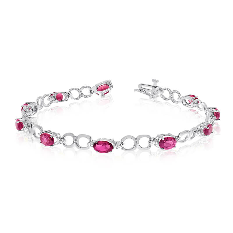 This 10k white gold oval ruby and diamond bracelet features ten 6x4 mm stunning natural ruby ston...
