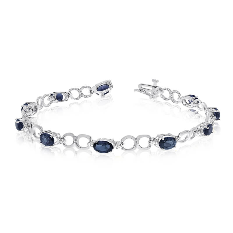 This 10k white gold oval sapphire and diamond bracelet features ten 6x4 mm stunning natural sapph...