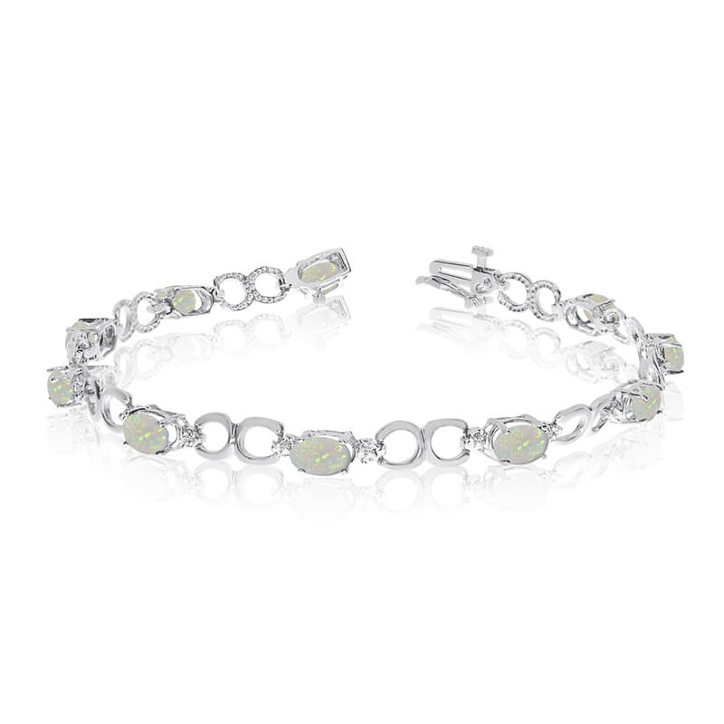 This 10k white gold oval opal and diamond bracelet features ten 6x4 mm stunning natural opal ston...