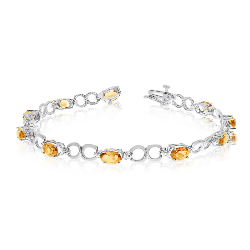 This 10k white gold oval citrine and diamond bracelet features ten 6x4 mm stunning natural citrin...