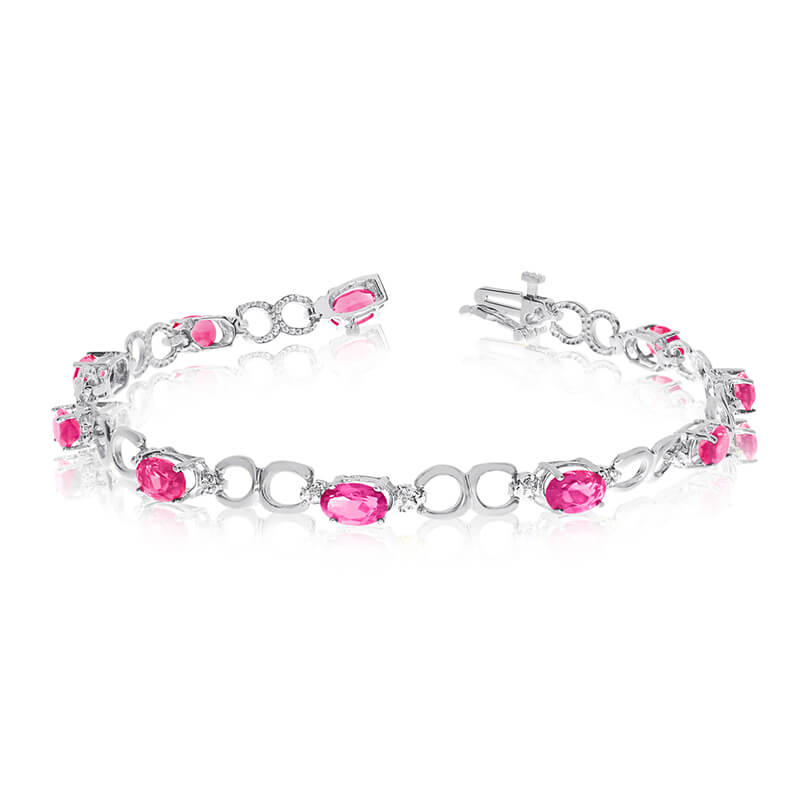 This 10k white gold oval pink topaz and diamond bracelet features ten 6x4 mm stunning natural pin...