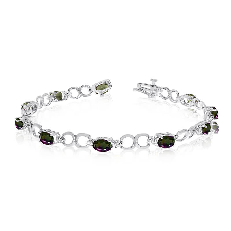 This 14k white gold oval mystic topaz and diamond bracelet features ten 6x4 mm stunning natural m...