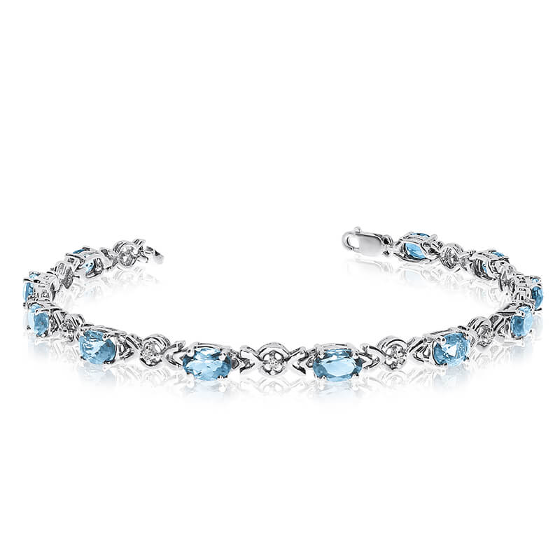 This 10k white gold oval aquamarine and diamond bracelet features eleven 6x4 mm stunning natural ...