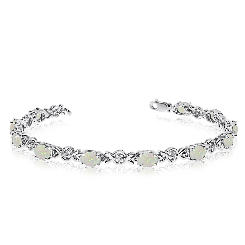 This 10k white gold oval opal and diamond bracelet features eleven 6x4 mm stunning natural opal s...