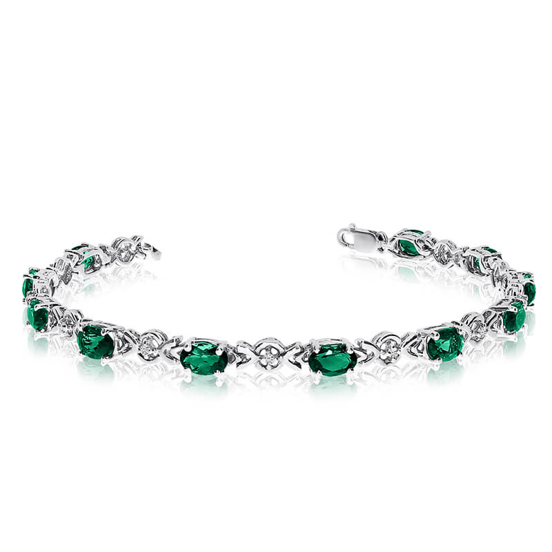 This 14k white gold oval emerald and diamond bracelet features eleven 6x4 mm stunning natural eme...