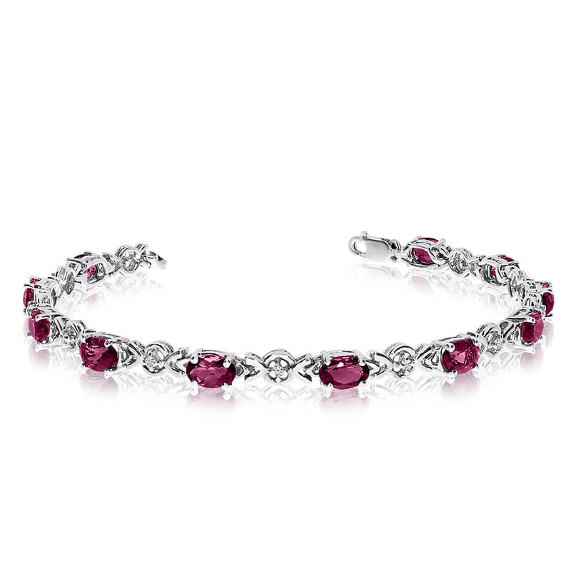 This 14k white gold oval ruby and diamond bracelet features eleven 6x4 mm stunning natural ruby s...
