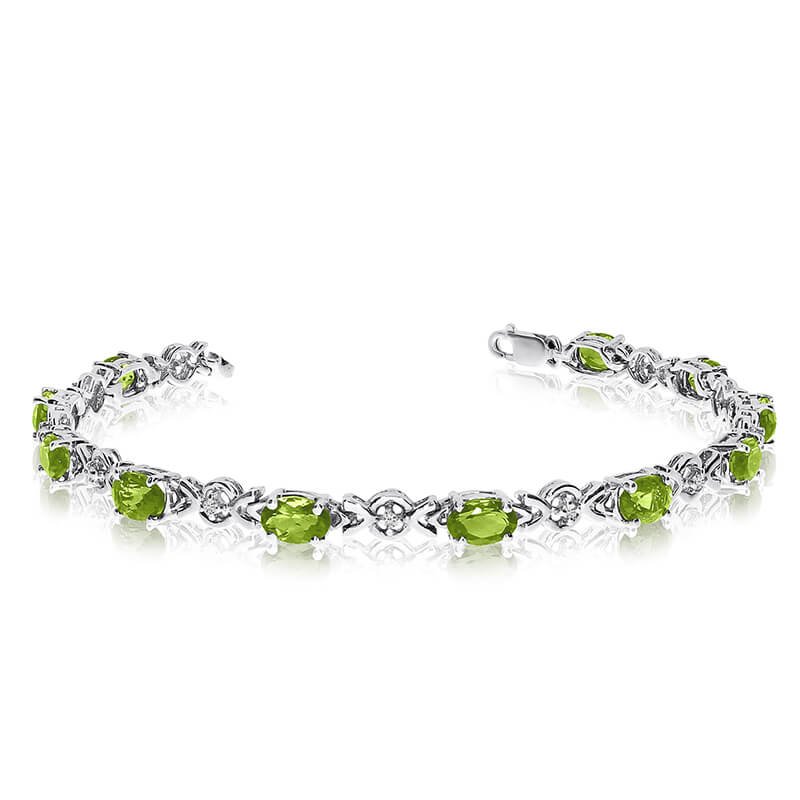This 14k white gold oval peridot and diamond bracelet features eleven 6x4 mm stunning natural per...