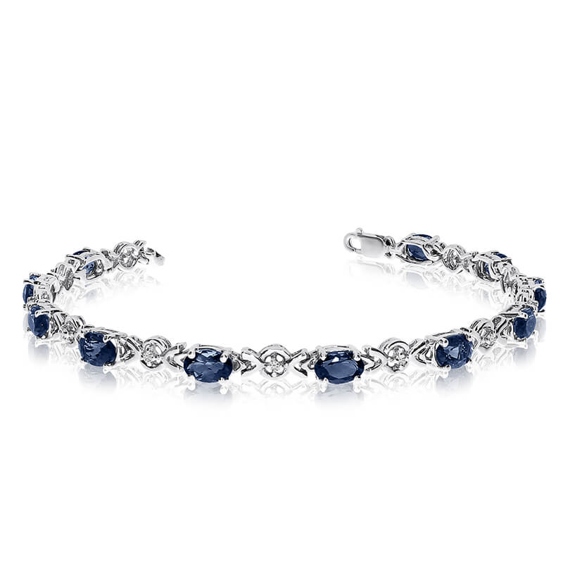 This 14k white gold oval sapphire and diamond bracelet features eleven 6x4 mm stunning natural sa...
