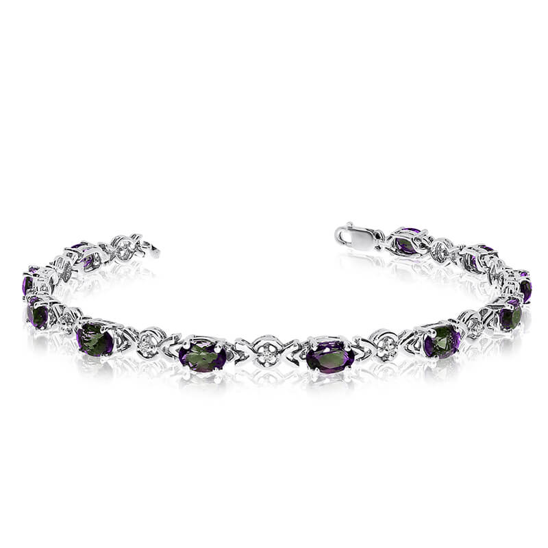 This 14k white gold oval mystic topaz and diamond bracelet features eleven 6x4 mm stunning natura...