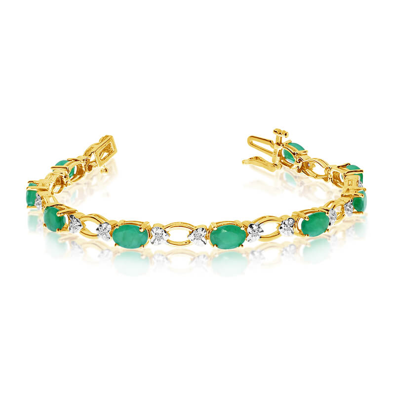 This 14k yellow gold natural emerald and diamond tennis bracelet features 12 oval emeralds with a...